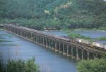 Color photograph of a train passing over the Rockville bridge.