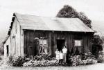 In this photograph, an Indian family poses outside a typical home on the Cornplanter Tract in the mid 1900s.  