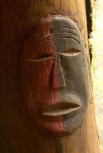 This carved and painted wood post replicates carvings found in the Big House. The dual color scheme, red and black, is symbolic of both good and evil and of life and death.'