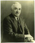 Milton S. Hershey, 3/4 length portrait; seated with legs crossed and hands on knees.
