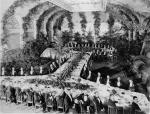 Photograph of officials from the Carnegie Companies, gathered together in a lavish ballroom. 