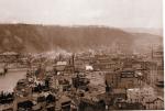 Black and white photograph of the view of downtown Johnstown Stoneycreek River on left of photo.