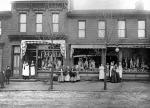 Butcher shop workers and shoppers pose outside of two Cambria City butcher shops'