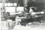 Interior of Axle shop and workers.'