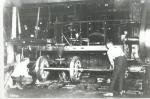 Interior image of workers mounting wheels to axles.'