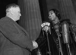 Secretary of the Interior Harold Ickes congratulates Miss Marian Anderson from the steps of the Lincoln Memorial.