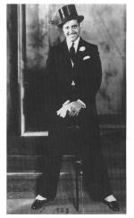 Image of Lorenzo Tucker in a tuxedo, wearing a top hat and holding a cane.