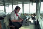 Edward Abbey working at a typewriter, surrounded by the windows and expansive views of his Arizona fire tower.