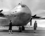 WAVE Sally Siebert from Pittsburgh and WAC Winifred Thompson inspect nose of the first large size cargo airplane constructed of stainless steel. WAVES and WACS stand near the huge tail at Budd Field, Red Lion Road and Reveree Road.   January 29, 1945. 