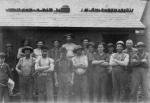 Group photograph of workers at the Shenango Furnace.  Front row, left to right:  Unknown (man with newspaper), Redmond, unknown, Childs, unknown, Ernest Rapp, Armour, Tim Moore Back row, left to right: Unknown, Cook, unknown, William Grundy (or Grandy), Jas. Wingard, unknown, Sam Clarke, unknown, Henry Bear (or Biar). 